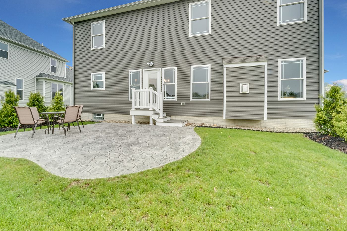 A completed concrete patio and steps behind a Colorado home.